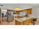 Kitchen features stainless steel appliances, light countertops and wooden cabinetry at 4142 El Shaddiai Sq, Plant City, FL 33565