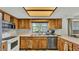 Cozy kitchen with stainless steel appliances and wood cabinets at 4142 El Shaddiai Sq, Plant City, FL 33565