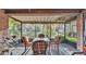 Inviting screened patio with a table and chairs, perfect for outdoor dining and relaxing at 4142 El Shaddiai Sq, Plant City, FL 33565