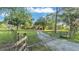 Gated property with a long driveway and mature trees, offering privacy and a serene setting at 4142 El Shaddiai Sq, Plant City, FL 33565