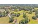 Expansive aerial view of a lush property featuring mature trees, a serene pond, and open green spaces at 4910 Thonotosassa Rd, Plant City, FL 33565