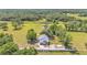 Beautifully landscaped property featuring mature trees and a well-maintained home with an attached garage at 4910 Thonotosassa Rd, Plant City, FL 33565