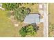 An aerial view of the house shows its roof, driveway, and surrounding green landscape at 4910 Thonotosassa Rd, Plant City, FL 33565