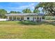 Expansive backyard view showing a well-maintained lawn and the rear of the home at 4910 Thonotosassa Rd, Plant City, FL 33565