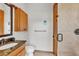 Bathroom featuring granite counters, vanity, toilet, and tiled shower with glass door at 4910 Thonotosassa Rd, Plant City, FL 33565
