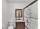 Cozy bathroom features a vanity with a brown cabinet and framed mirror over a sink and shower at 4910 Thonotosassa Rd, Plant City, FL 33565