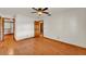 Bedroom with hardwood floors, a ceiling fan, and an open closet at 4910 Thonotosassa Rd, Plant City, FL 33565