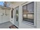 Front entrance boasts classic door with decorative glass and white painted brick at 4910 Thonotosassa Rd, Plant City, FL 33565