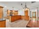 Well-lit kitchen featuring wooden cabinetry, tile floors, modern appliances, and plenty of counter space for cooking and meal preparation at 4910 Thonotosassa Rd, Plant City, FL 33565