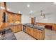 Spacious kitchen features granite countertops, wood cabinets, stainless steel appliances, tile flooring at 4910 Thonotosassa Rd, Plant City, FL 33565