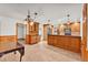 Spacious kitchen with wooden cabinetry, tile floors, modern appliances, and plenty of counter space for cooking and meal preparation at 4910 Thonotosassa Rd, Plant City, FL 33565