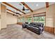 Bright living room features vaulted ceilings, wood beams, tile floors, and large windows at 4910 Thonotosassa Rd, Plant City, FL 33565