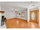 Bright living room featuring hardwood floors, a decorative fireplace, natural light from the windows, and decorative wood shutters at 4910 Thonotosassa Rd, Plant City, FL 33565