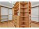 Spacious walk-in closet with custom wooden shelving and drawers provides ample storage at 4910 Thonotosassa Rd, Plant City, FL 33565