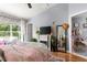Bright bedroom with large windows, a cozy fireplace, and stylish decor and ensuite bathroom at 2125 Wild Grape Pl, Riverview, FL 33578