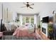 Cozy bedroom featuring a decorative headboard, fireplace, and a view to the outdoors at 2125 Wild Grape Pl, Riverview, FL 33578