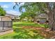 Community area boasts a green lawn with mature trees, a picnic shelter, and manicured landscaping at 2125 Wild Grape Pl, Riverview, FL 33578