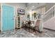 Open dining area with cute decor, an accent wall, and a bright blue door for a pop of color at 2125 Wild Grape Pl, Riverview, FL 33578