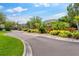 Well-maintained community entrance with brick pavers and vibrant landscaping at 2125 Wild Grape Pl, Riverview, FL 33578