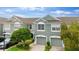 Inviting townhome with attached garages, complemented by well-maintained landscaping and a serene sky view at 2125 Wild Grape Pl, Riverview, FL 33578