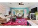 Bright living room featuring hardwood floors, large windows, stylish decor, and comfortable seating at 2125 Wild Grape Pl, Riverview, FL 33578