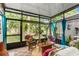 Enclosed sunroom with plants and comfortable seating, creating an inviting relaxation space at 2125 Wild Grape Pl, Riverview, FL 33578