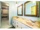 Well-lit bathroom with a double sink vanity, decorative mirrors, and a walk-in shower at 4101 N Forbes Rd, Plant City, FL 33565