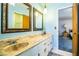 Bathroom showcasing a double sink vanity with marble countertops, framed mirrors, and a separate toilet area at 4101 N Forbes Rd, Plant City, FL 33565