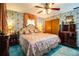 Inviting bedroom with light blue wallpaper, matching curtains, and decorative wood accents at 4101 N Forbes Rd, Plant City, FL 33565