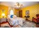 Cozy bedroom with colorful floral bedspread, matching rug, and decorative yellow wallpaper at 4101 N Forbes Rd, Plant City, FL 33565