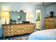 Bedroom features ornate dressers, blue carpet, and access to the bathroom at 4101 N Forbes Rd, Plant City, FL 33565