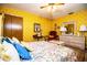 Comfortable bedroom with floral bedding, complementing the bright yellow wallpaper at 4101 N Forbes Rd, Plant City, FL 33565