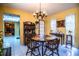 Welcoming dining area with wooden furniture and a decorative hutch, illuminated by a vintage chandelier at 4101 N Forbes Rd, Plant City, FL 33565