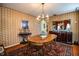 The dining room is finished with an oval wood table and a china cabinet with decorated plates at 4101 N Forbes Rd, Plant City, FL 33565
