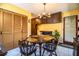 Cozy dining room features a chandelier, dark cabinets, and wood-style closet doors at 4101 N Forbes Rd, Plant City, FL 33565