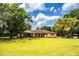 Charming single-story home featuring a manicured lawn, mature trees and a welcoming facade at 4101 N Forbes Rd, Plant City, FL 33565