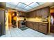 Spacious kitchen features wood cabinets, stainless steel oven, tile flooring and a bright, skylight-lit ceiling at 4101 N Forbes Rd, Plant City, FL 33565