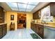Bright kitchen with wood cabinets, stainless steel appliances, and a sunlit skylight at 4101 N Forbes Rd, Plant City, FL 33565