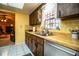 Bright kitchen with wooden cabinets, stainless steel appliances, and a sunlit window above the sink at 4101 N Forbes Rd, Plant City, FL 33565