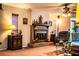 Cozy living room featuring a brick fireplace, comfortable seating, and charming decor at 4101 N Forbes Rd, Plant City, FL 33565