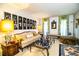 A vintage living room with a patterned sofa, glass coffee table, and large windows with green drapes at 4101 N Forbes Rd, Plant City, FL 33565
