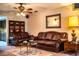Inviting living room featuring leather furniture and carpeted floors at 4101 N Forbes Rd, Plant City, FL 33565