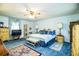 Bright main bedroom featuring blue carpet, a ceiling fan, and well-crafted wooden furniture at 4101 N Forbes Rd, Plant City, FL 33565