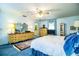 The main bedroom has blue carpet, a ceiling fan, and painted dressers at 4101 N Forbes Rd, Plant City, FL 33565
