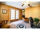 Cozy office space featuring wood trim, carpet floors, a ceiling fan, and French doors leading to the outdoors at 4101 N Forbes Rd, Plant City, FL 33565