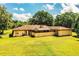 Backyard with lush green grass, screened-in porch, and exterior chimney at 4101 N Forbes Rd, Plant City, FL 33565