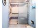 Walk-in shower with decorative blue and white tiles, grab bar, and glass sliding door at 4101 N Forbes Rd, Plant City, FL 33565