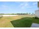 Large grassy backyard surrounded by a white vinyl fence at 8009 Sail Clover Ln, Zephyrhills, FL 33540