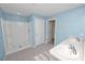 Well-lit bathroom featuring a shower, double sinks, and blue walls at 8009 Sail Clover Ln, Zephyrhills, FL 33540