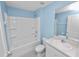 Clean bathroom features a shower-tub combo and vanity with sink at 8009 Sail Clover Ln, Zephyrhills, FL 33540